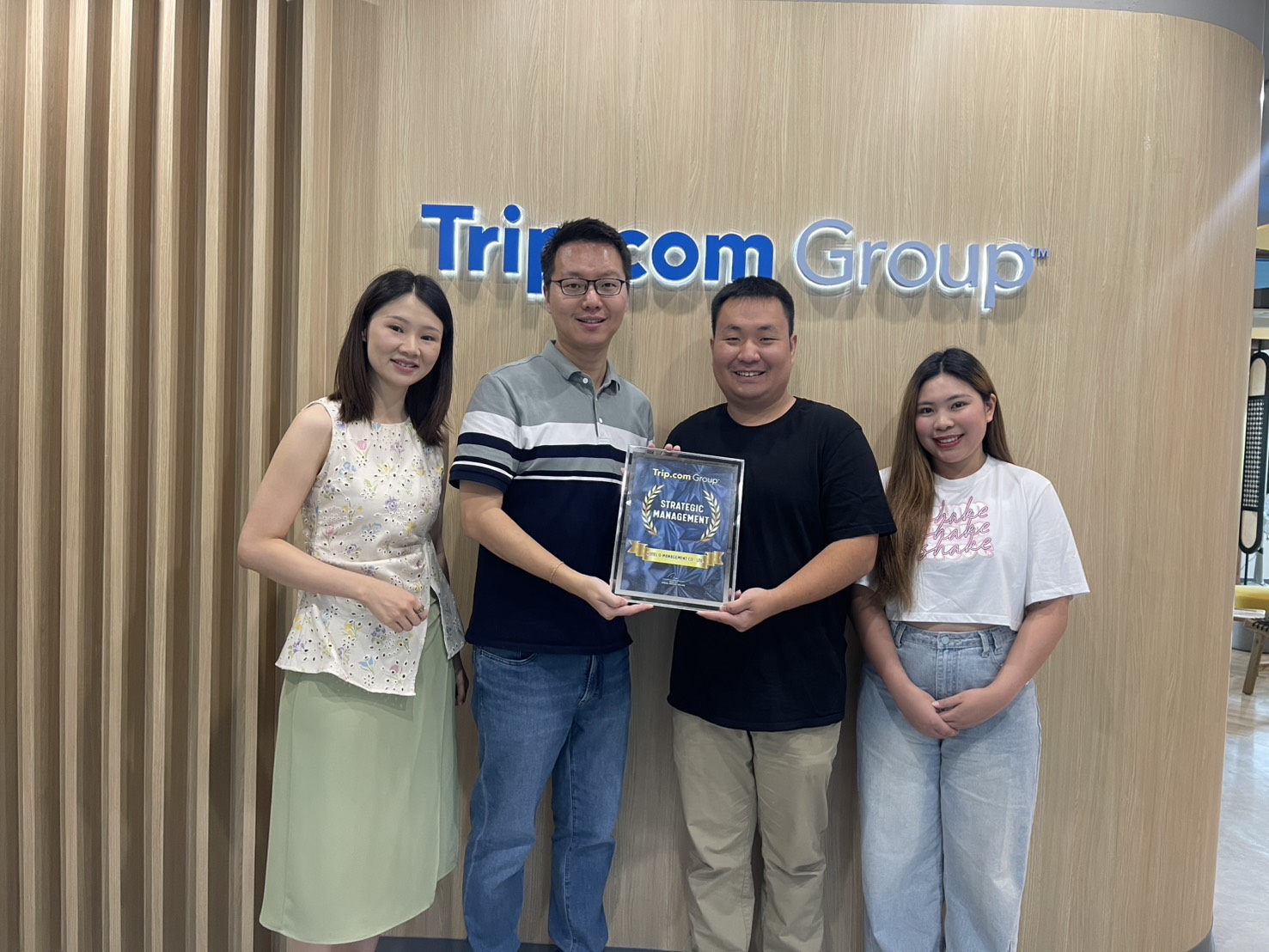Hotel D team receiving Strategic Management recognition from Trip.com Group